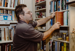 Mark sorts books in his antique shop.