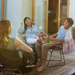 Friends sitting on a patio and chatting