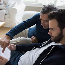 Father and son research home buying.
